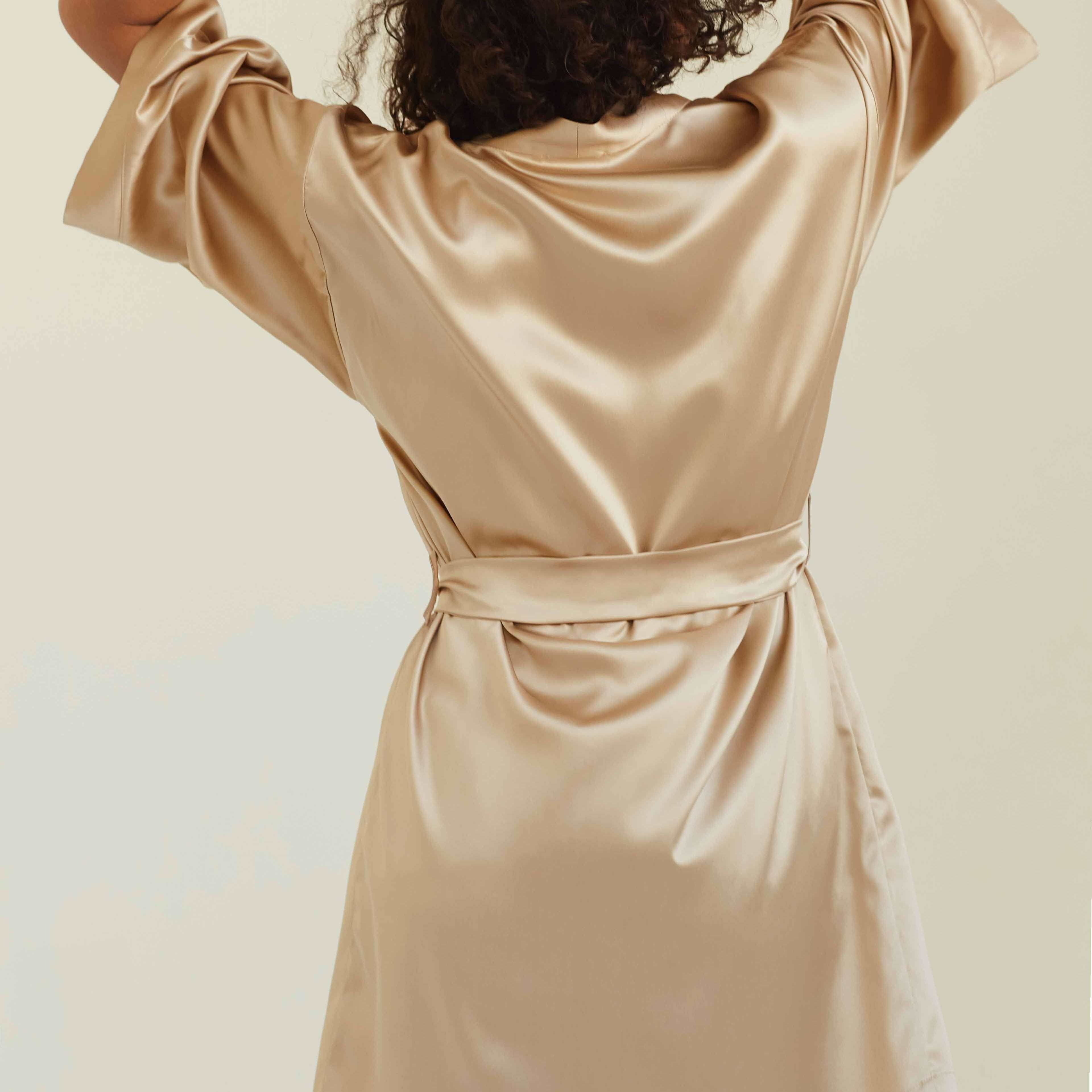 Beige Back view of the beige silk robe, showcasing the elegant and smooth drape of the fabric.
