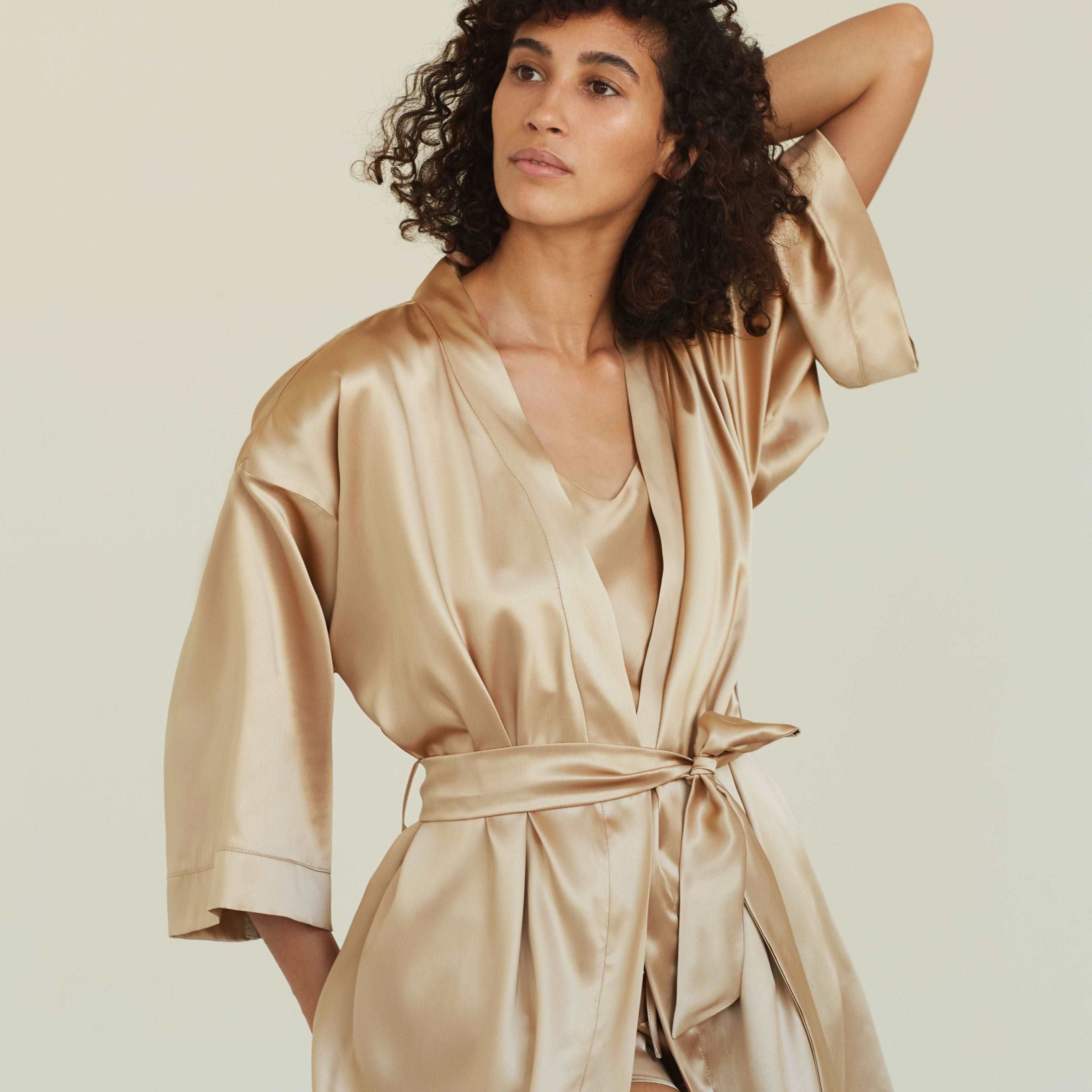 Beige Model wearing a beige silk robe, demonstrating the relaxed fit and luxurious sheen of the material.