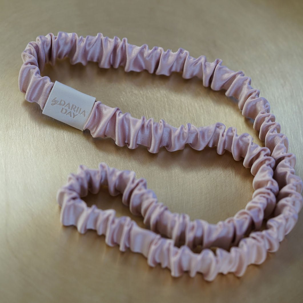 Pink A luxurious blush pink silk headband by Dariia Day, displayed on a golden tray, perfect for adding a touch of elegance to your hair accessories collection