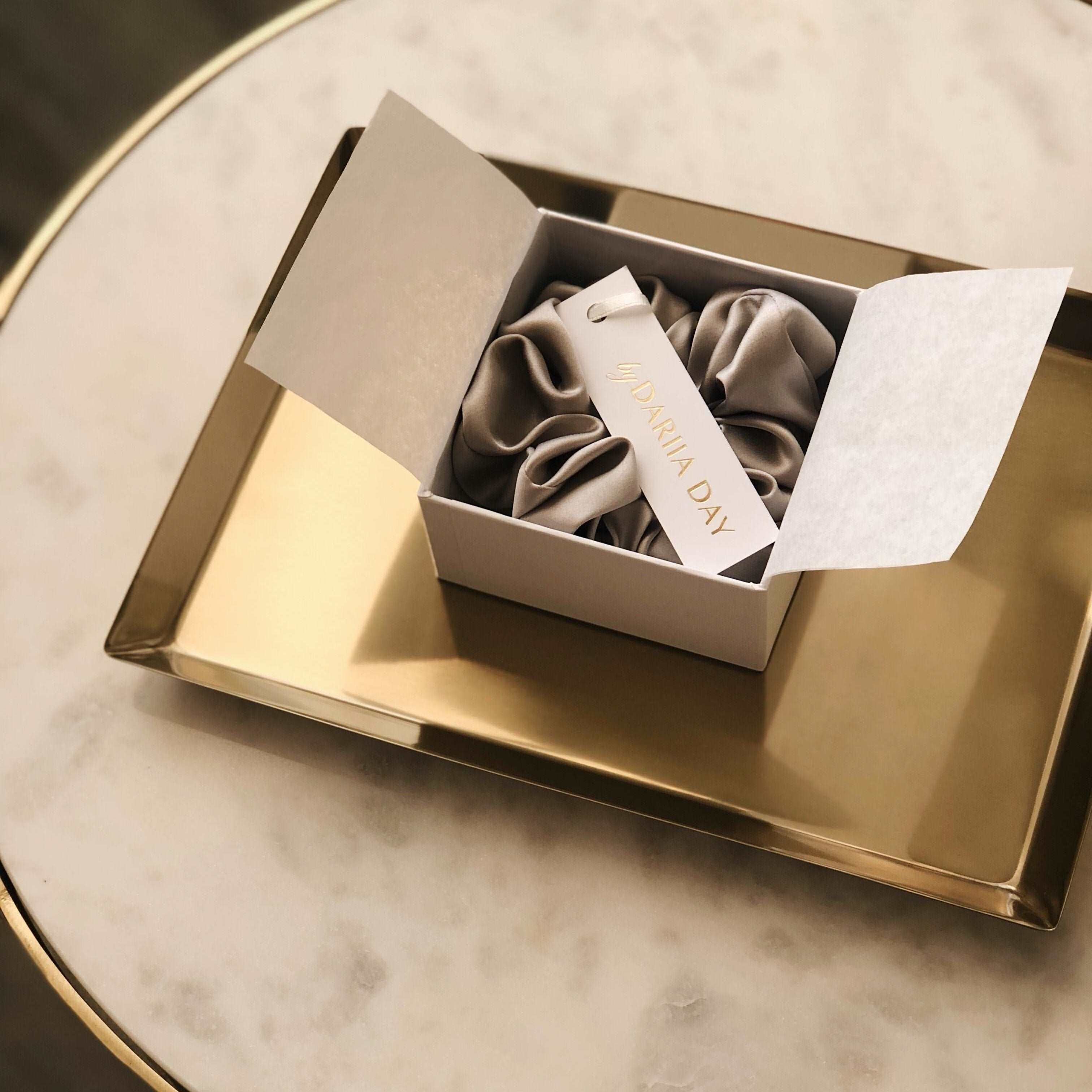 Grey Luxury grey silk scrunchie by Dariia Day in a beautifully presented gift box, ideal for a thoughtful and stylish gift.