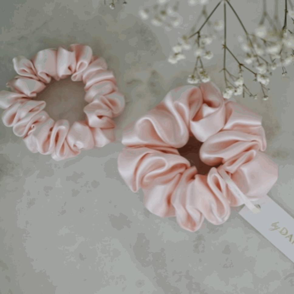 Pink Blush pink silk scrunchie set by Dariia Day on a marble surface.