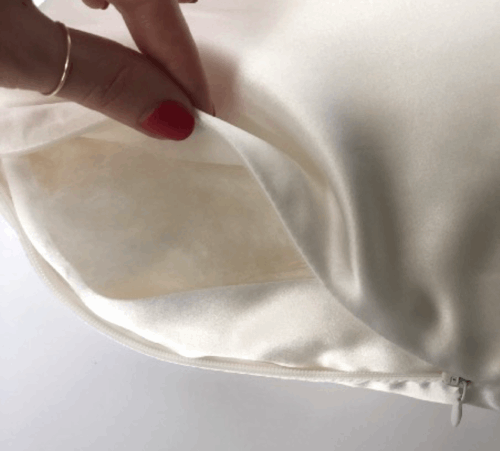 Pink Close-up of a Dariia Day silk pillowcase zipper detail, highlighting the smooth fabric and hidden closure.