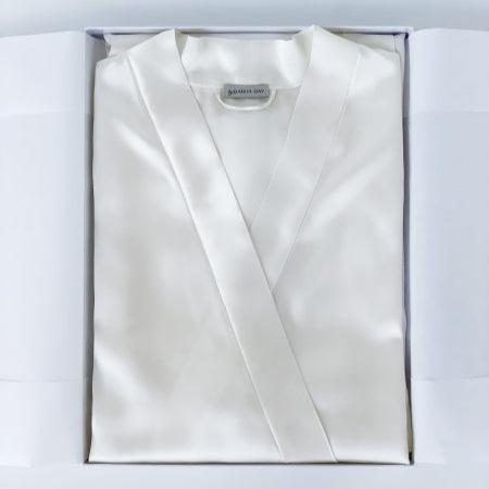 White Powder white silk robe by Dariia Day, neatly folded in a gift box with the brand label visible.