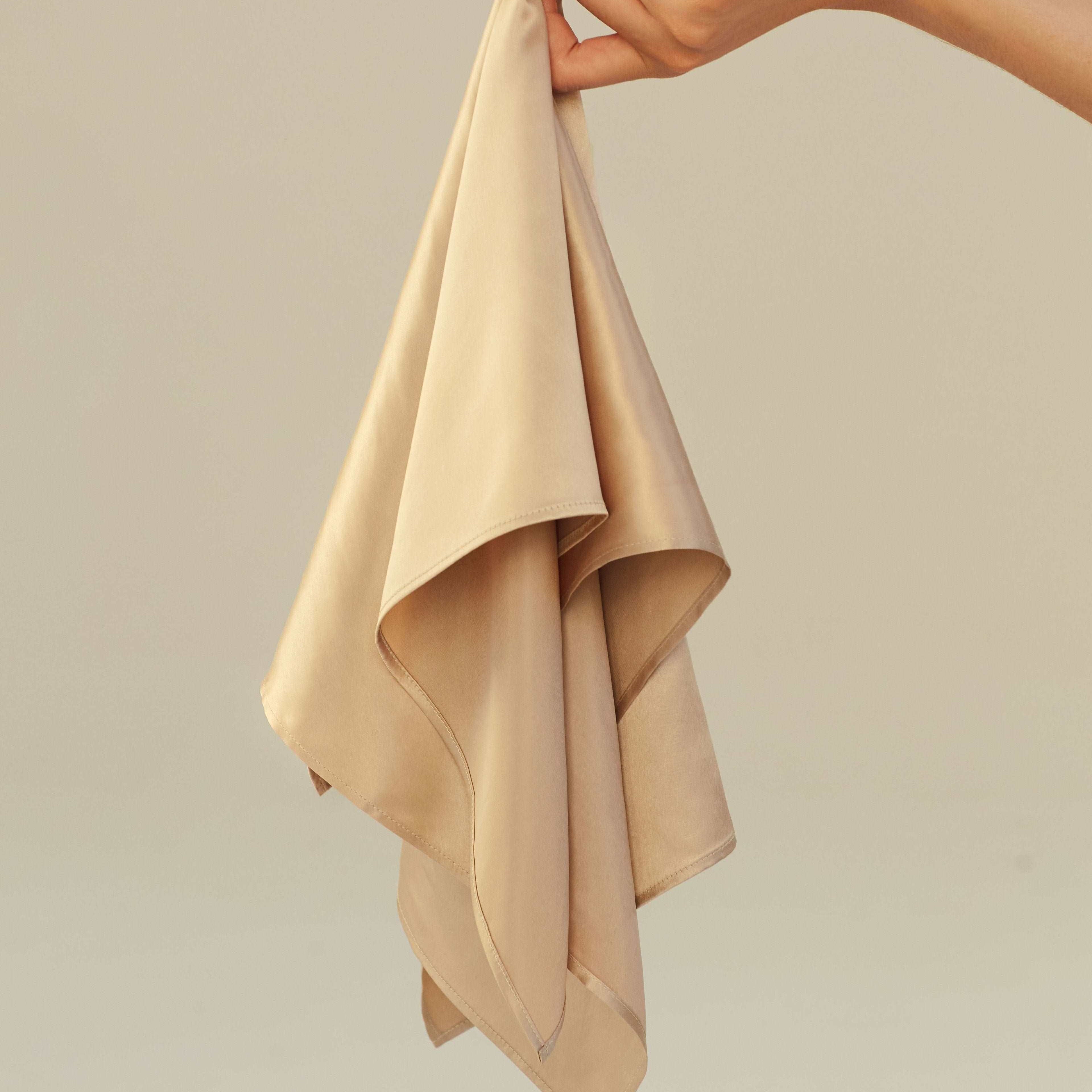 Beige A woman wearing a French beige silk scarf by Dariia Day, tied elegantly around her neck, minimal and stylish look