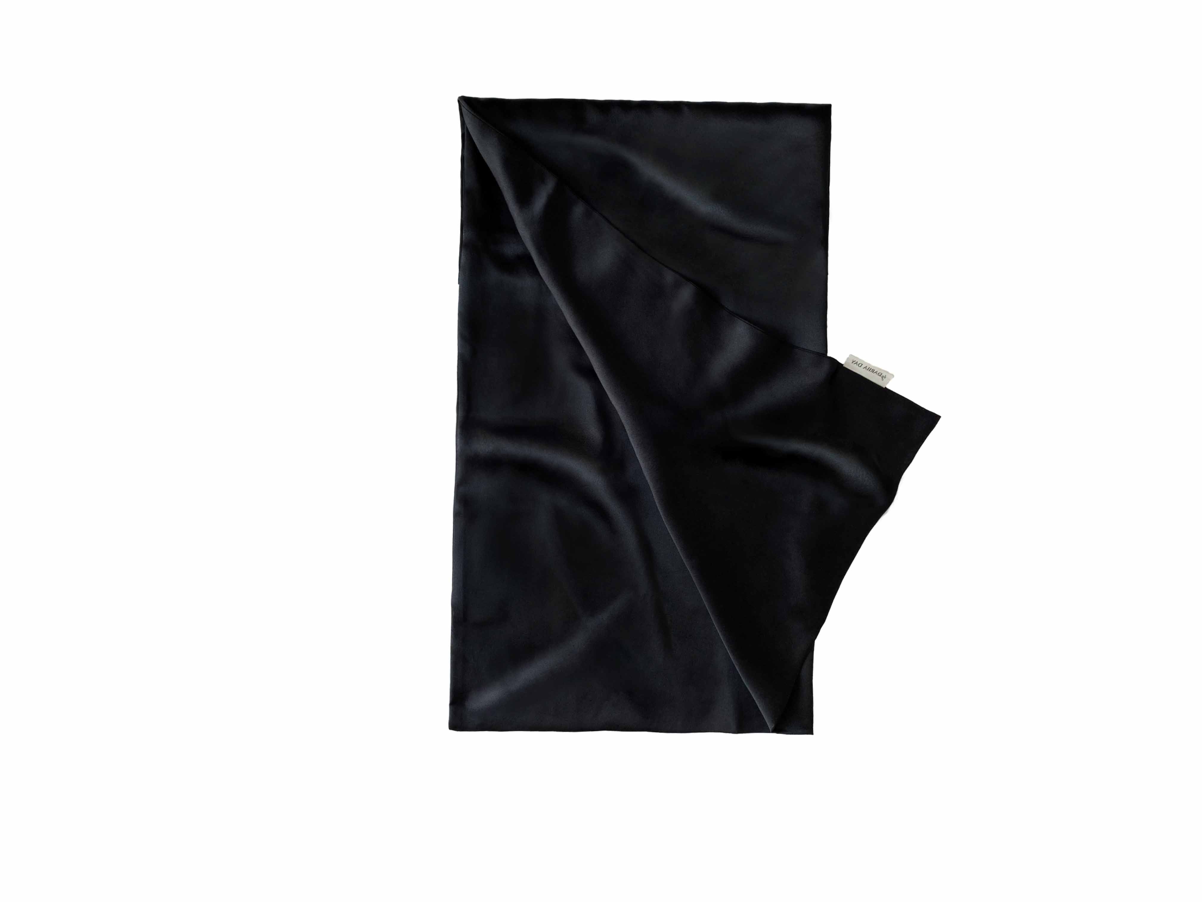 Elegant black silk pillowcase with luxurious sheen, featuring the by Dariia Day label.