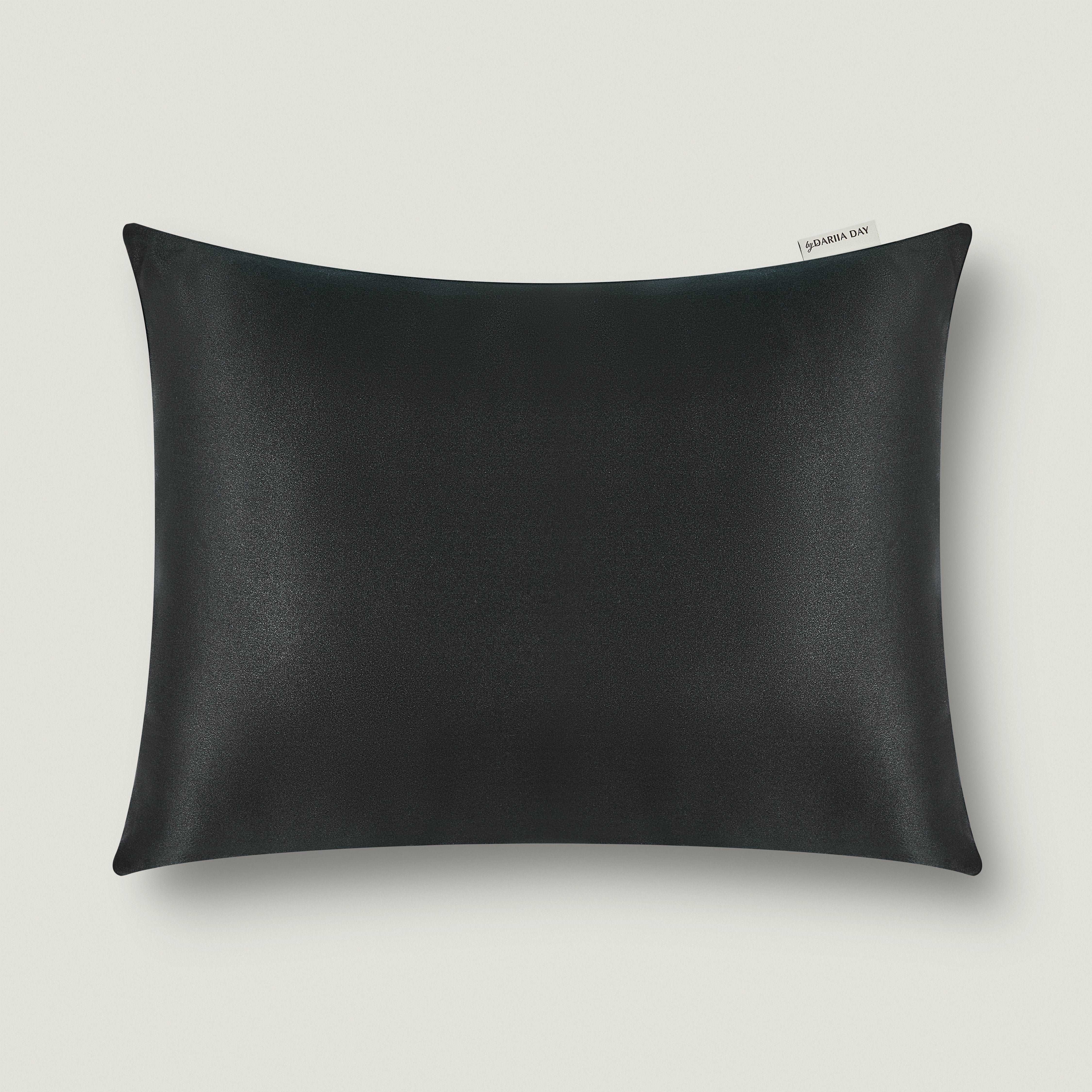 Dariia Day silk travel pillow in Midnight Black, offering sleek and luxurious comfort for travel.