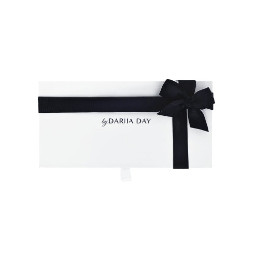 Elegant gift box by Dariia Day wrapped with a black ribbon, perfect for gifting luxury silk and beauty accessories.