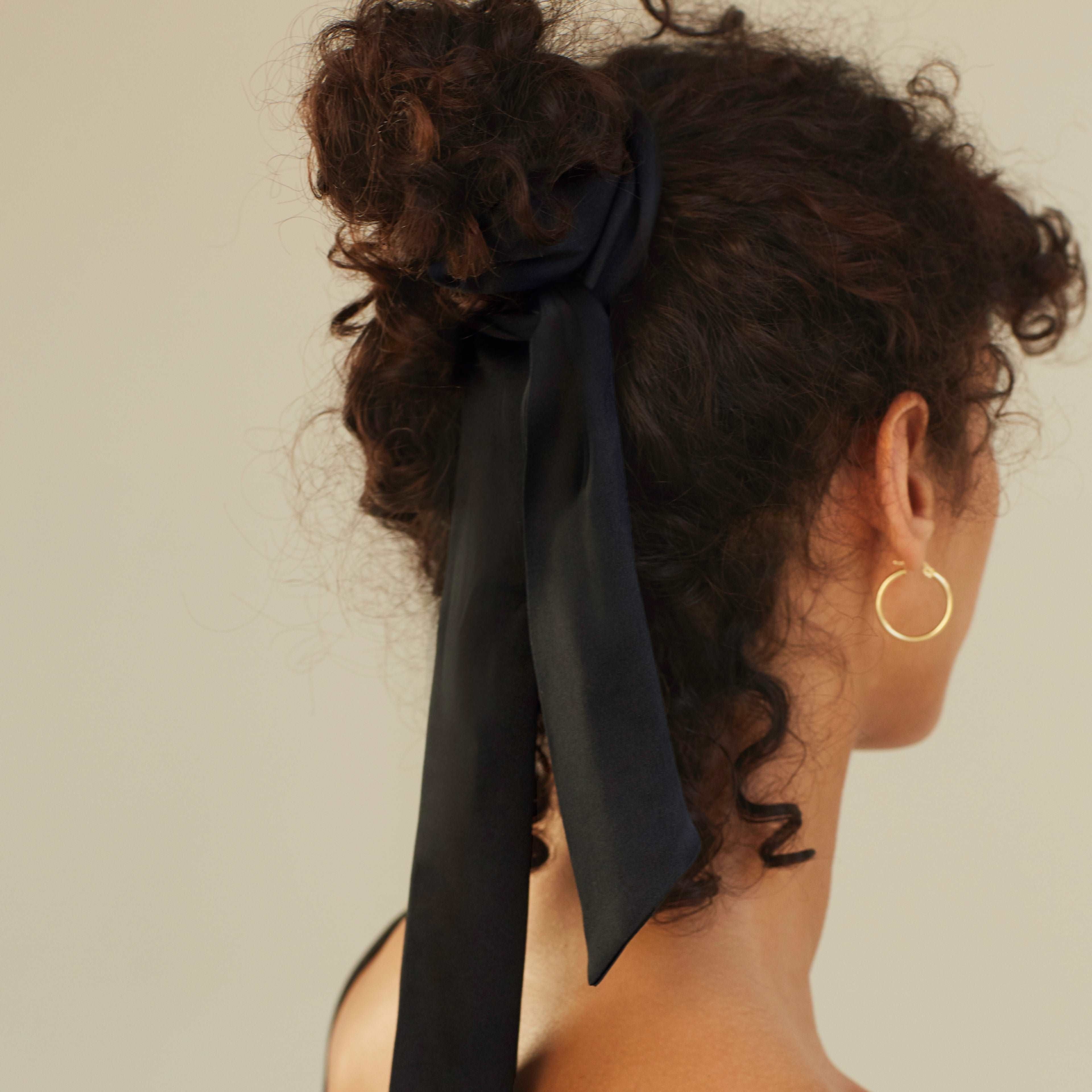 Black Woman wearing a silk scarf in midnight black as a hair accessory, by Dariia Day