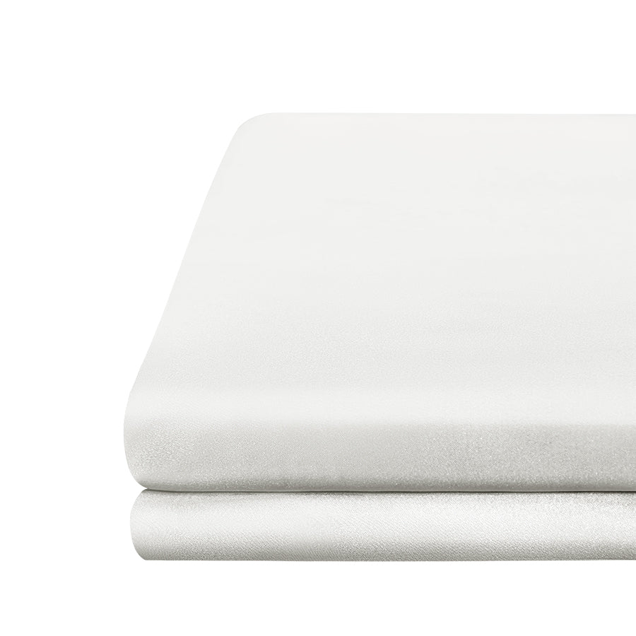 Neatly folded powder white silk fitted sheet, showcasing the smooth and lustrous texture of silk fabric.
