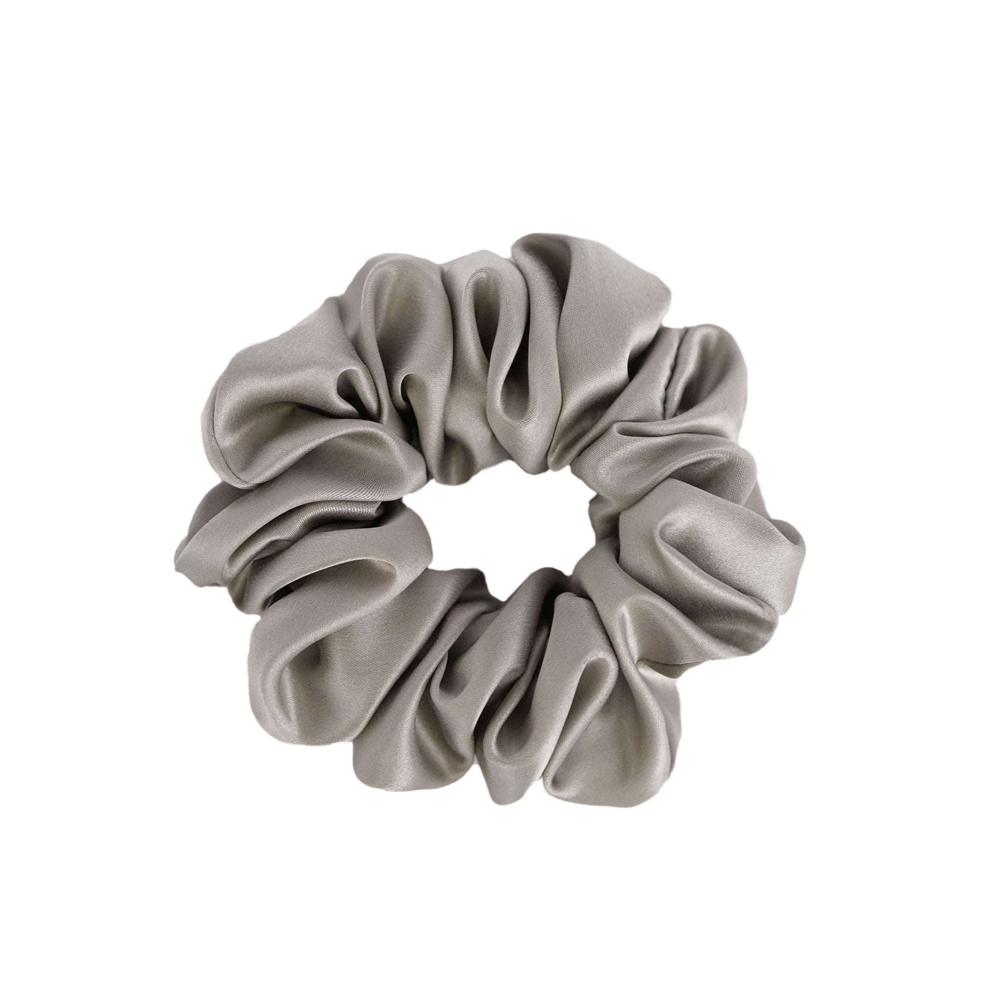 Elegant grey medium silk scrunchie by Dariia Day, shown in a simple and stylish display, made from premium mulberry silk.