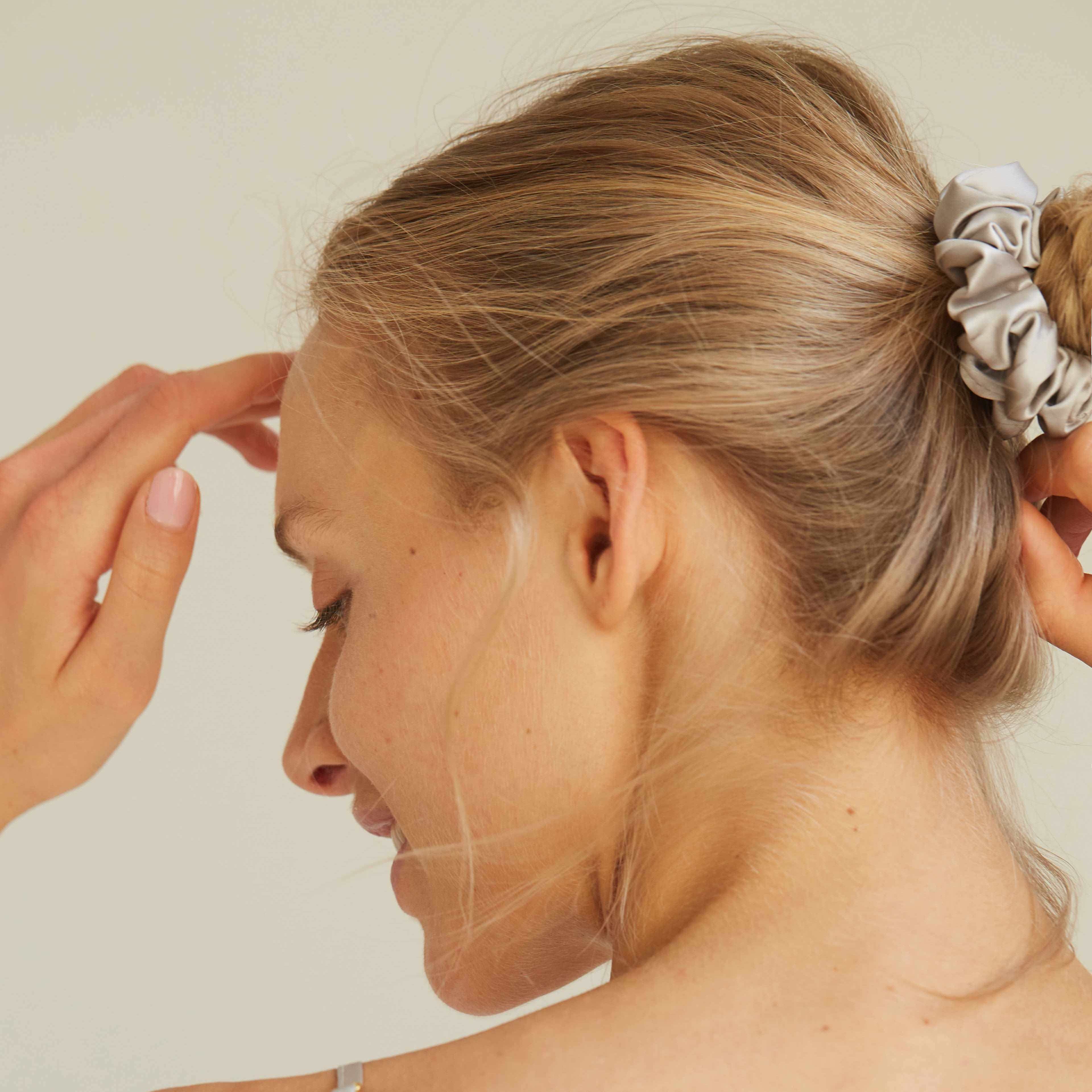 Grey Back view of model wearing a grey silk scrunchie by Dariia Day, demonstrating the chic and functional design.