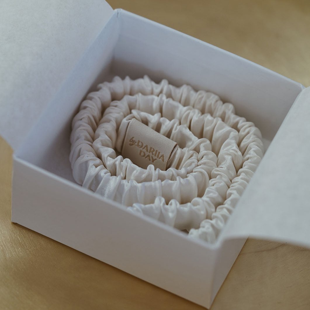 Close-up of by Dariia Day Powder White Silk Headband neatly packed in a luxurious white box, made from high-quality mulberry silk.