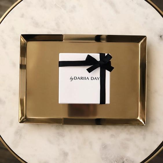 Pink White gift box with black ribbon by Dariia Day, displayed on a gold tray, perfect for gifting luxury silk products.