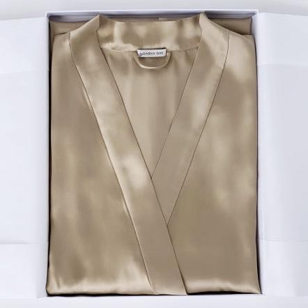 Beige silk robe by Dariia Day, neatly folded in a gift box with the brand label visible.