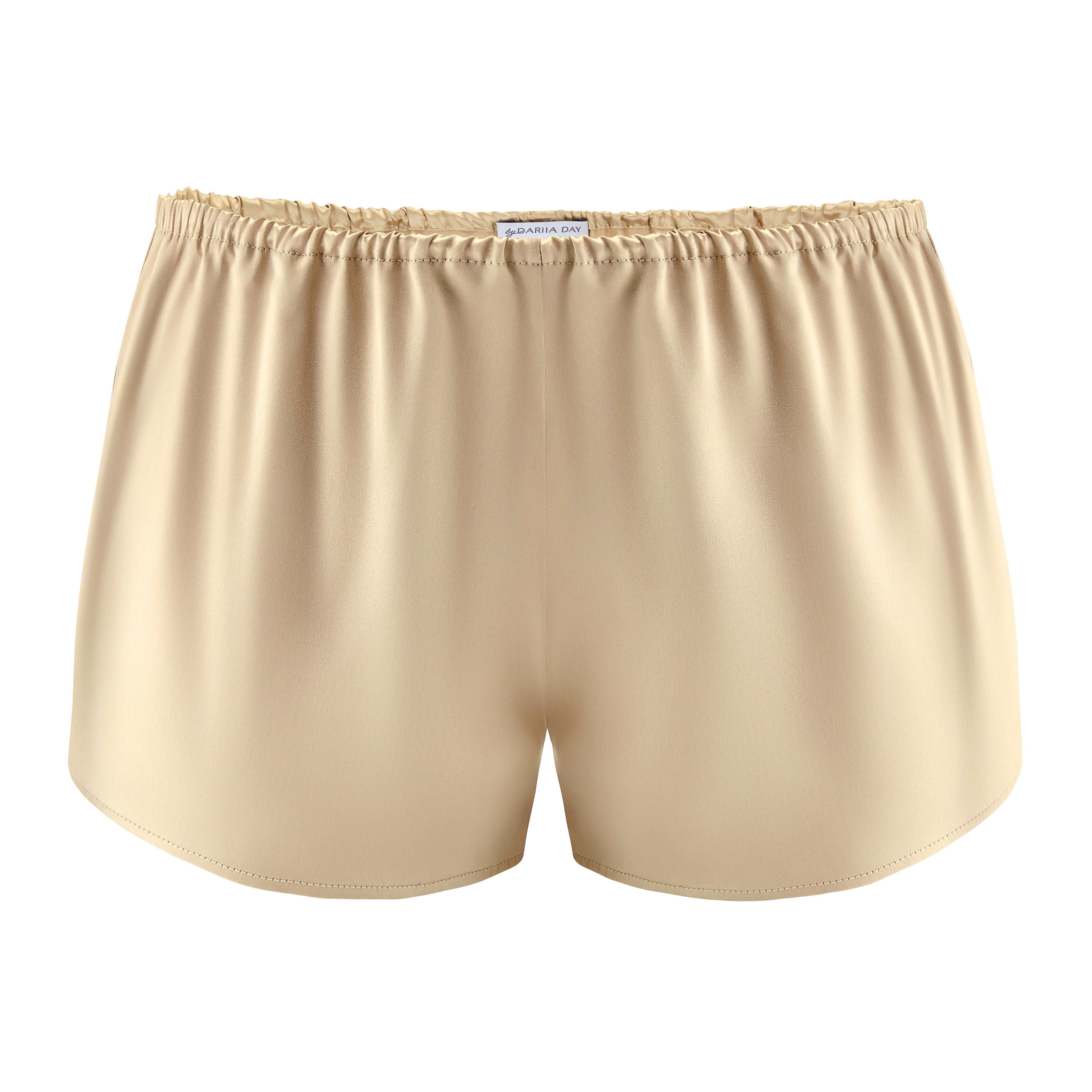 Front view of beige silk shorts by Dariia Day, showcasing smooth satin texture.