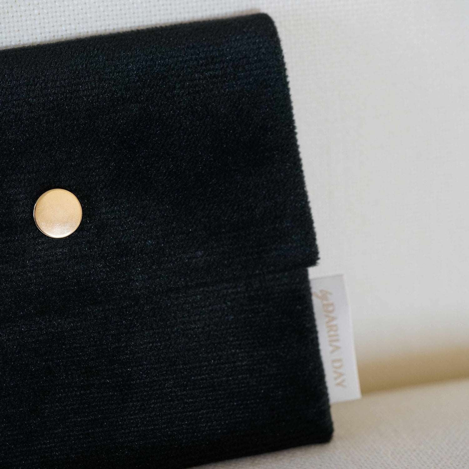 Dariia Day Midnight Black Velvet Pouch featuring the Dariia Day label, with a gold button detail.