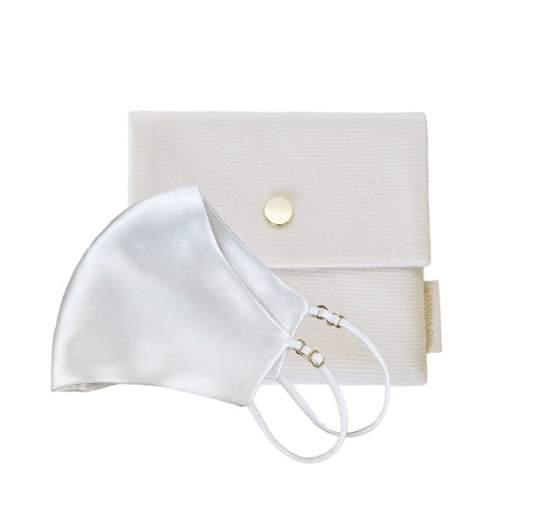 White Powder white silk face mask by Dariia Day, paired with a matching white pouch featuring a gold button closure.