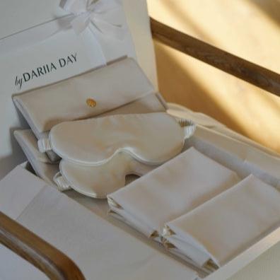 Silk wedding gift set by Dariia Day, featuring an eye mask, velvet pouches, and pillowcases neatly displayed in an elegant box.