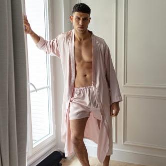 Close-up of a man wearing blush pink silk boxers by Dariia Day, showcasing the soft fabric and relaxed fit.