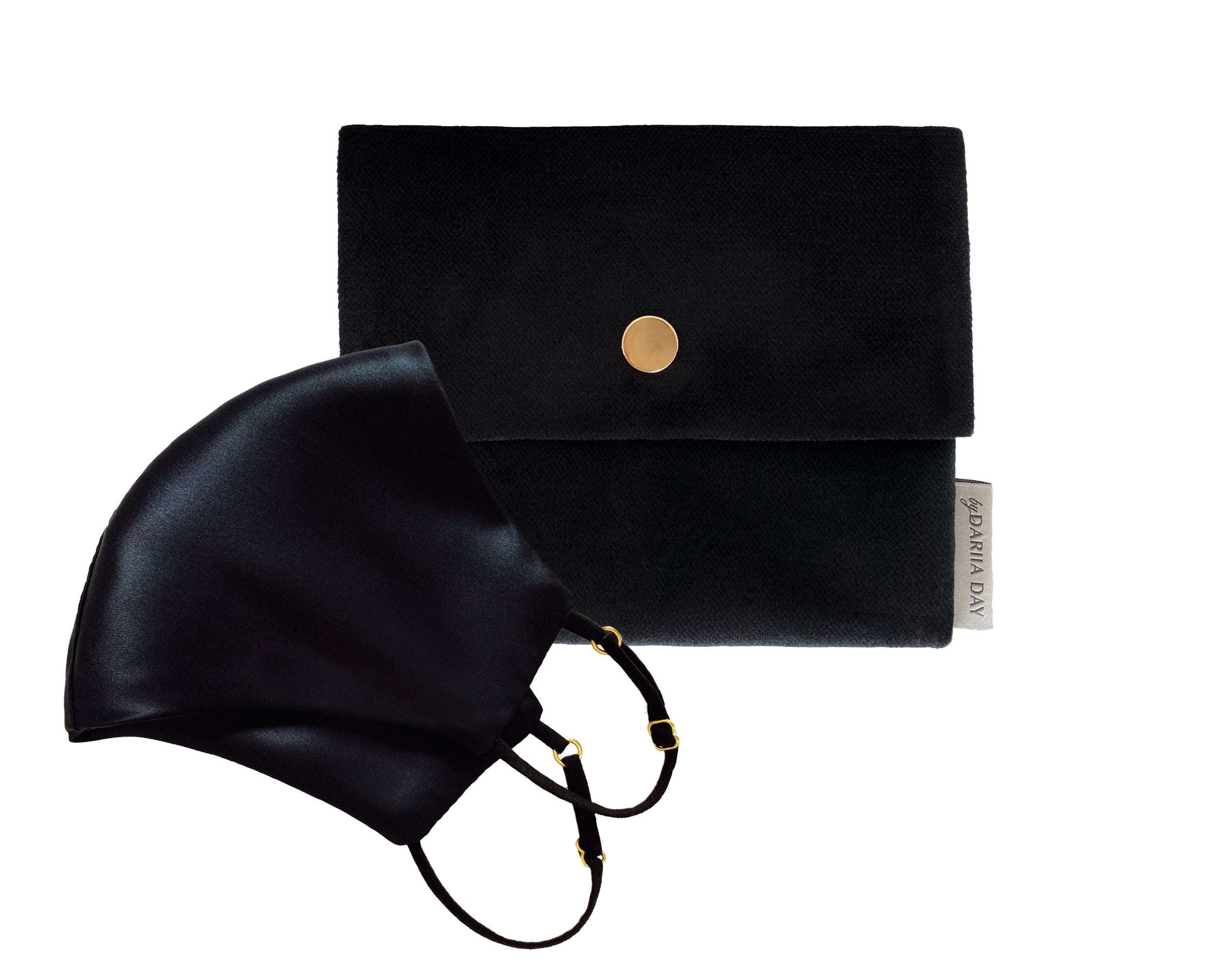 Midnight black silk face mask paired with a matching black pouch from Daria Day, featuring gold accents.