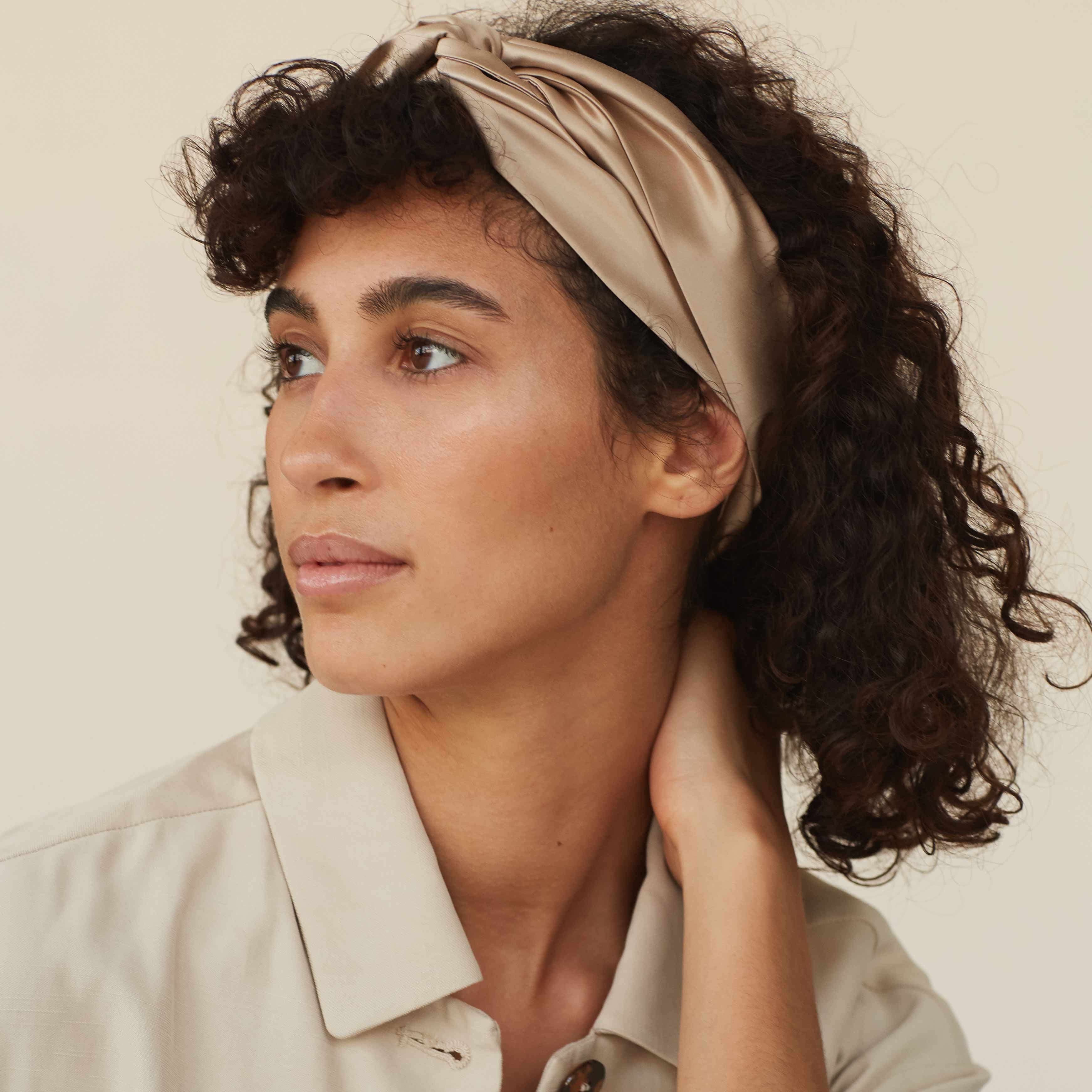 Beige silk scarf worn as a headband by Dariia Day