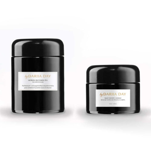 Silky Body Candle and Morning Blooming Tea by Dariia Day in black jars, showcasing a luxurious ritual set.