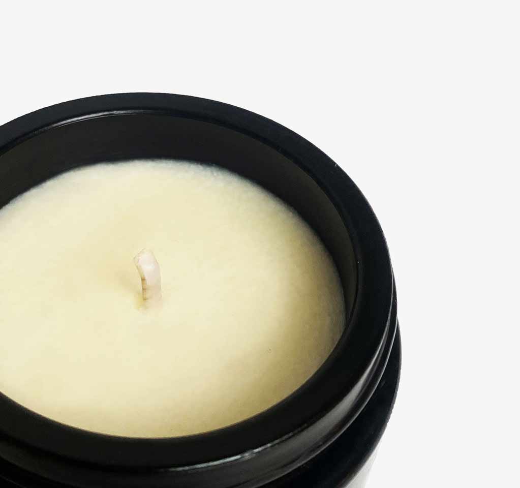 Open Silky Body Candle by Dariia Day with the lid placed beside it, showing the creamy wax texture.